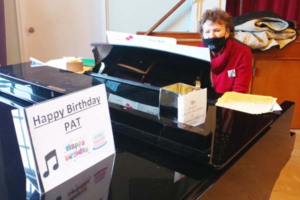 Pat Yatsko playing Christmas music on the piano. It happens to be her birthday.